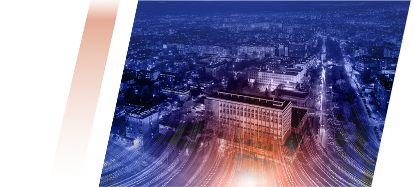 Computer monitor showing a logo draft on a grid inside a design program, with plants in the background and orange/blue decorative shapes nearby.